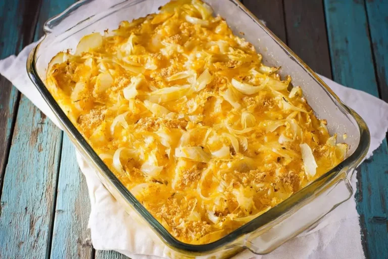 A warm Vidalia Onion and Rice Casserole in a glass baking dish, featuring golden cheese, sliced onions, and a crumb topping.