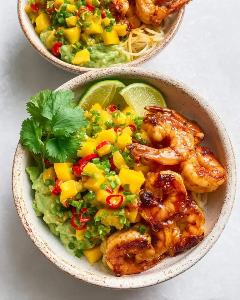 Shrimp Avocado Bowls with Mango Salsa featuring grilled shrimp, fresh mango chunks, and lime wedges in ceramic bowls.
