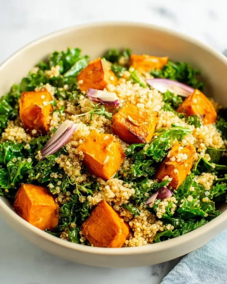 A bowl of Sweet Potato Kale and Quinoa Salad with roasted sweet potato cubes, fresh kale, and fluffy quinoa.