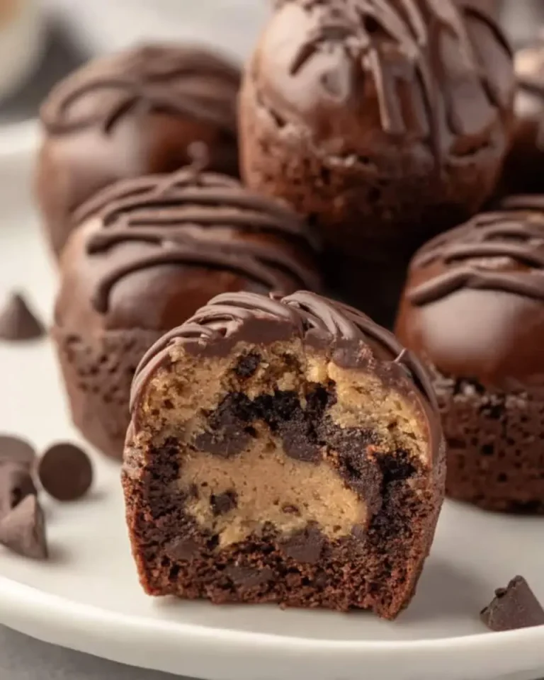 Chocolate Chip Cookie Dough Brownie Bites with one cut open to show the cookie dough center.